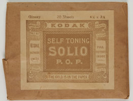 Rectangular brown paper envelope with gold-brown and white sticker label. 