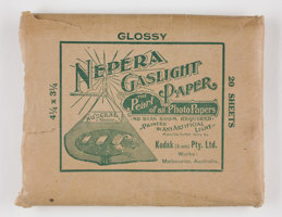 Rectangular brown paper envelope with green printed text, torn open at one end.