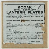 Brown cardboard box with a white paper label that is torn around the edges