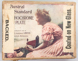 Box with a label  that has black text and image of a woman holding a camera