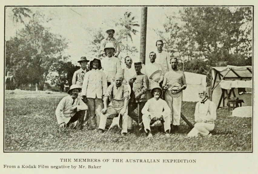 Expedition members grouped in a field for a staged photograph circa 1911