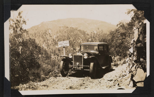 Old style car on a track in the mountains