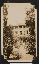 A view of a large house with garden in the foreground