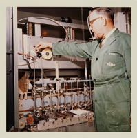 Man wearing green overalls operating machinery