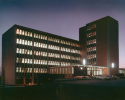 External view of a building with lights on at night