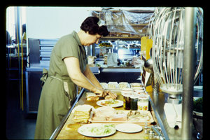 Woman preparing food in a commercial kitchen
