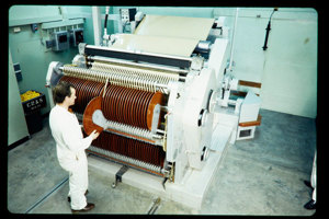 Man operating a larger machine with rollers