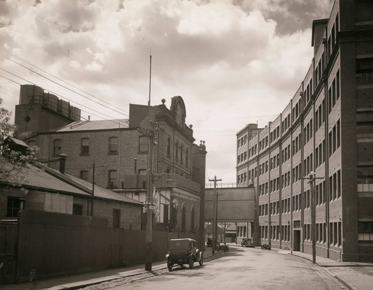 Curved street lined with multi-story brick buildings