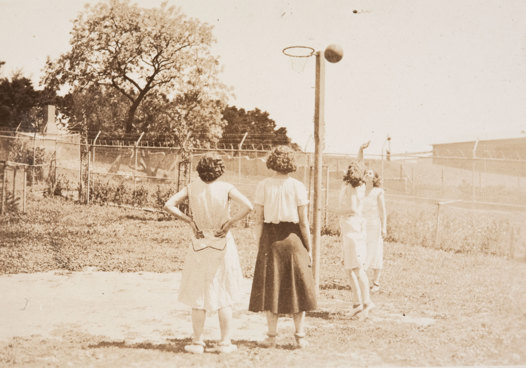 Four women around basketball hoop