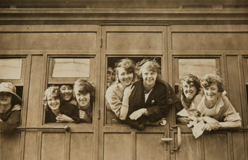 People leaning out train windows