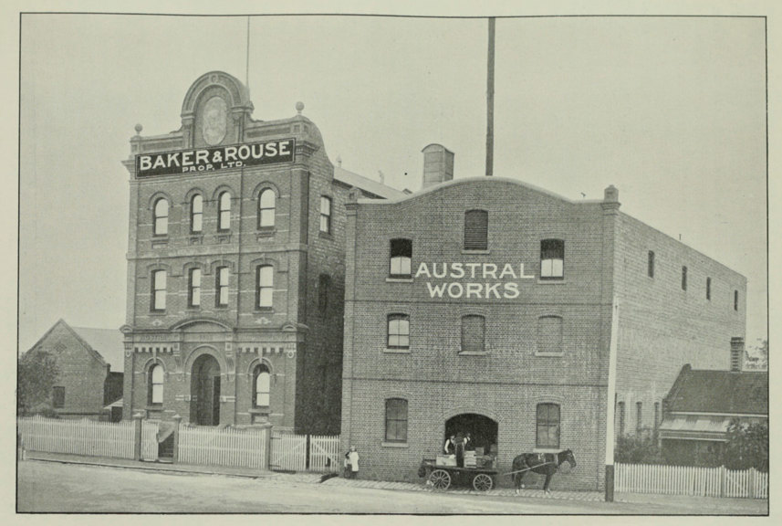 Horse and cart in front of multi-story brick buildings 