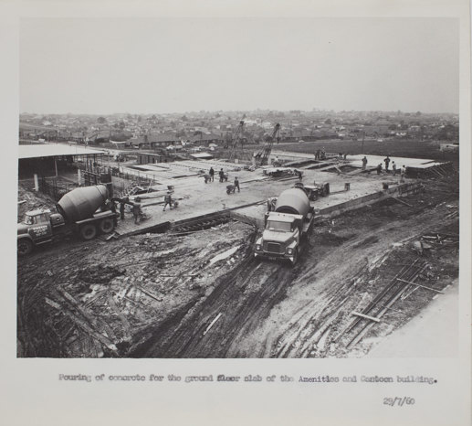 Construction site with concrete mixer trucks in the foreground