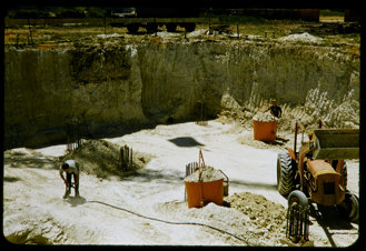Excavation site with a tractor and a workman