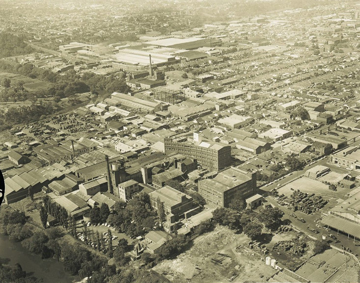 Ariel view of a urban area including factory buildings and river