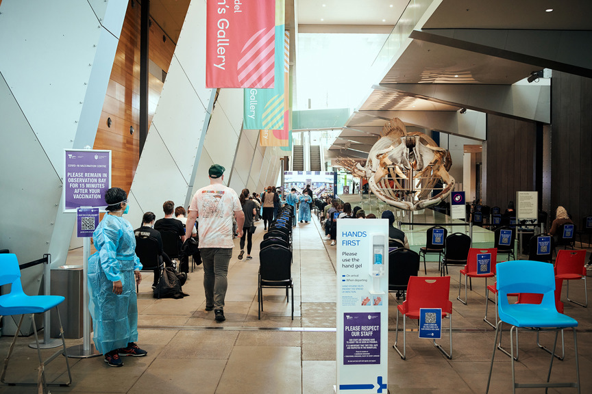 A photo of people in a vaccine waiting area