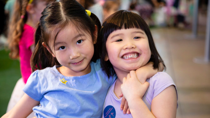 Two young girls smiling at the camera