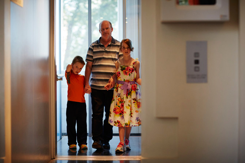 Family coming out of the elevator in Immigration Museum.