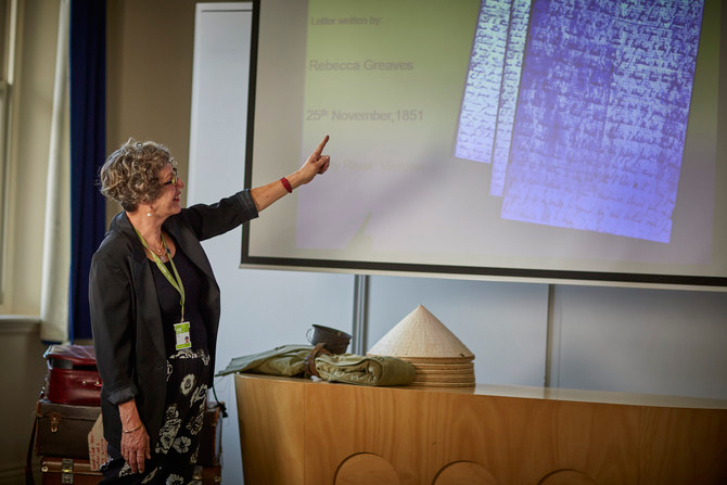 Woman pointing at projector screen.