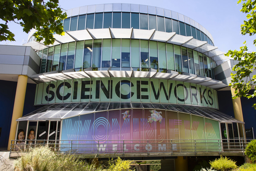 a circular building covered with colourful illustrations and the word Scienceworks