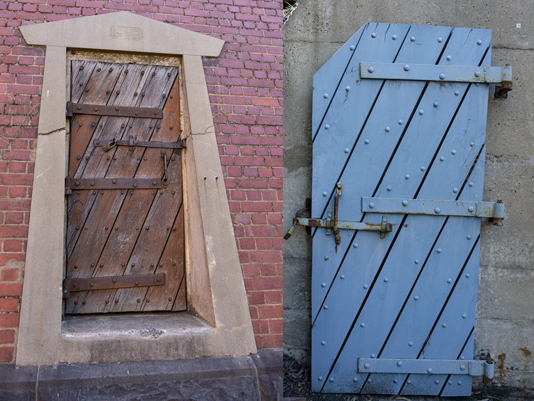 a wooden door inset in a brick wall