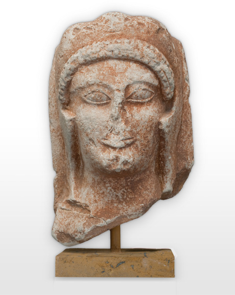 Statue head with worn away facial features