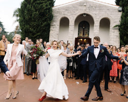Crowd watching people dancing in circle and holding hands 