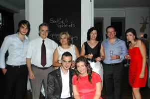 6 people standing behind two seated people.