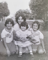 Four young people kneeling on grass