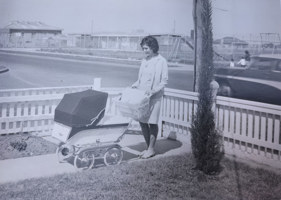 Woman with pram in garden