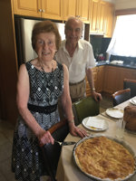 Elderly couple standing near a vasilopita