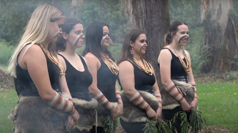 Five women participating in a ceremony