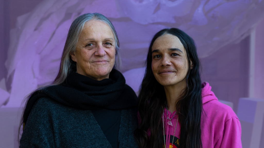 Two woman pose for a photograph