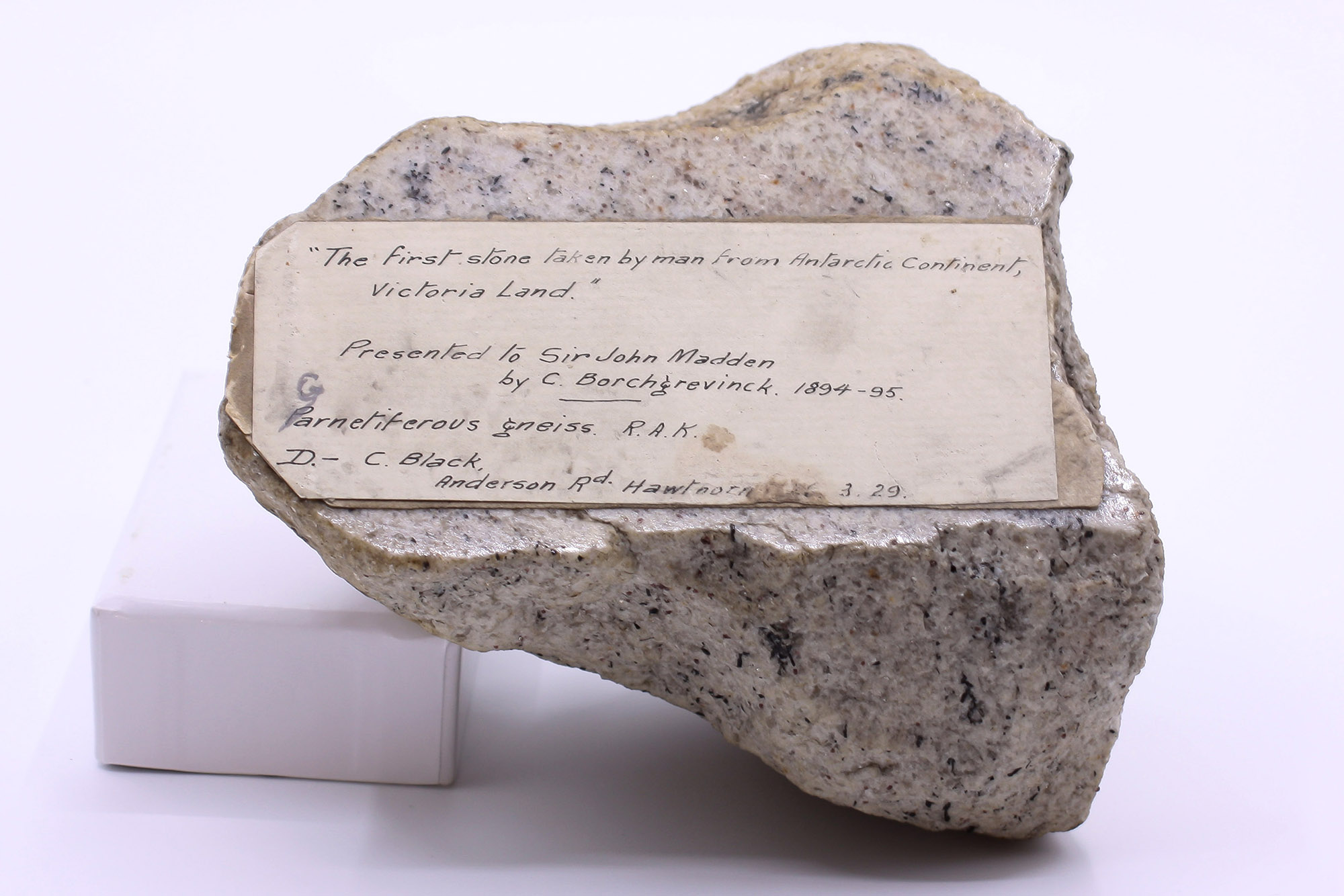 A speckled rock featuring a hand written label