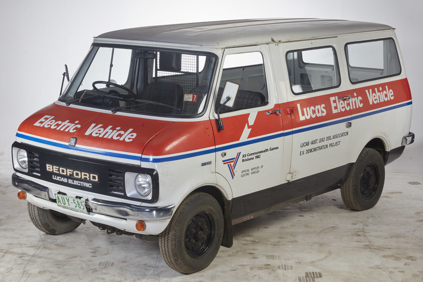a photo of a white van with red and blue stripes across the side
