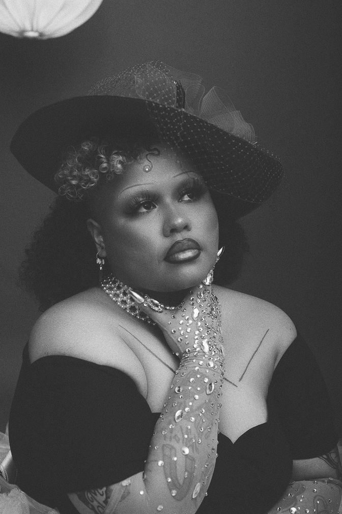 Black and white image of Kaiit posing for portrait