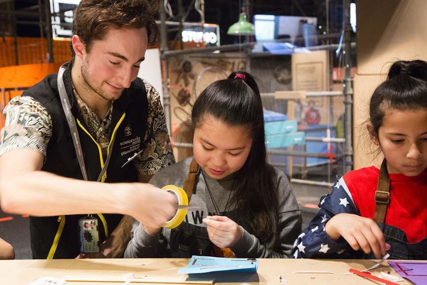 Two girls making a light-up card with a Scienceworks' staff member in Test Lab.