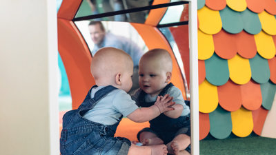 Baby looking in a mirror
