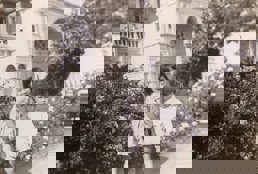 Two children near rose bushes outside Exhibition Building.