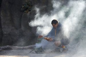 Man squat partially enclosed in smoke