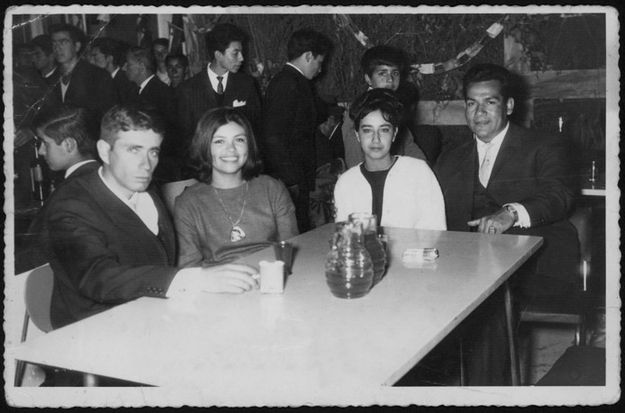 Black and white image of a group of people sitting at a table