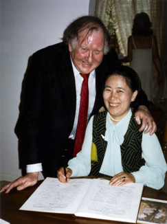 Man and woman signing a document