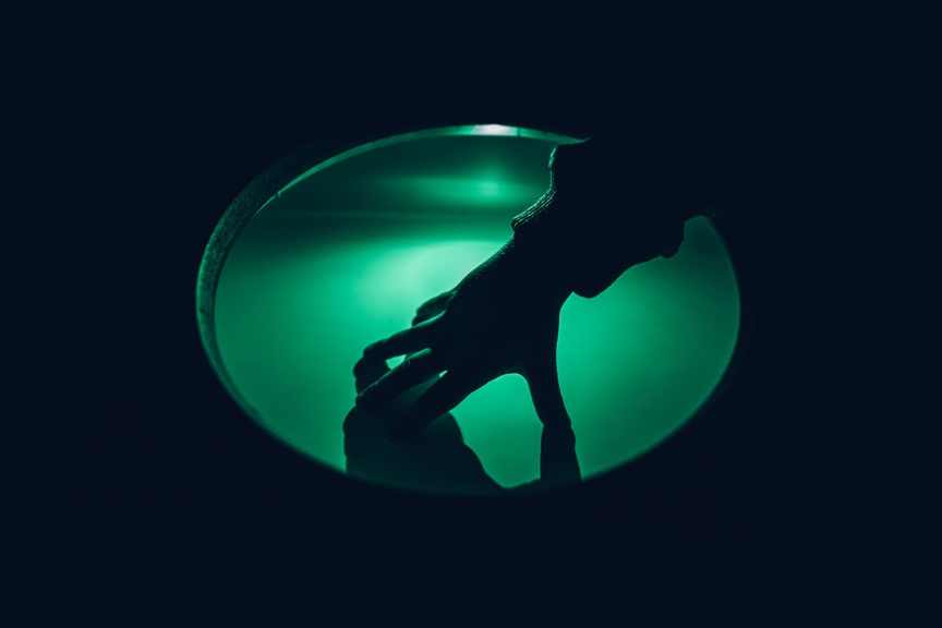 Hand on green light disc