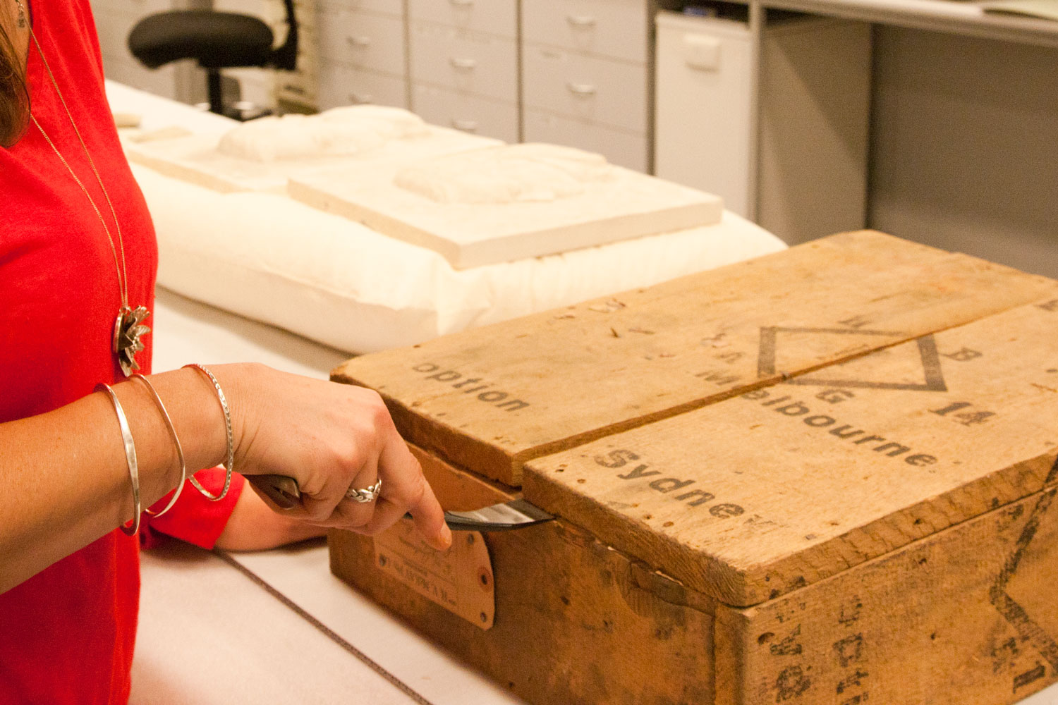 Conservator opening up sealed crate