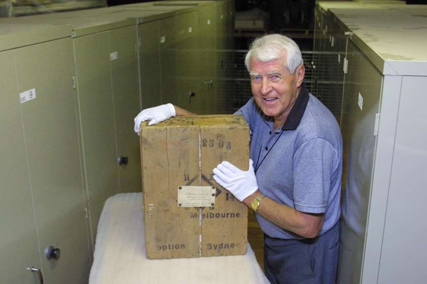 Man with a crate in a museum store