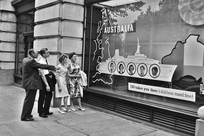 Two men and two women looking in a shop window