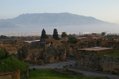 Pompeii ruins are in the foreground, Vesuvius is seen in the background 