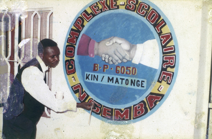 Nickel Mundabi painting a harmony mural at Ngemba School, where he taught art. The school is in the Matonge district of Kinshasa the capital city of the Democratic Republic of Congo.