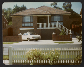 Taxi parked in front of taxi drivers house, 1975.