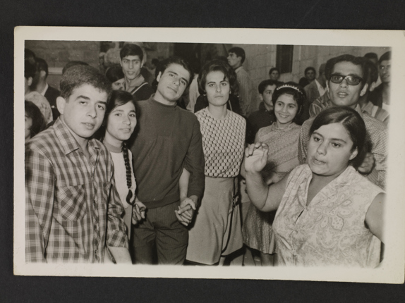 Group portrait and a woman dancing dabke in Hadchit, ca. 1968.