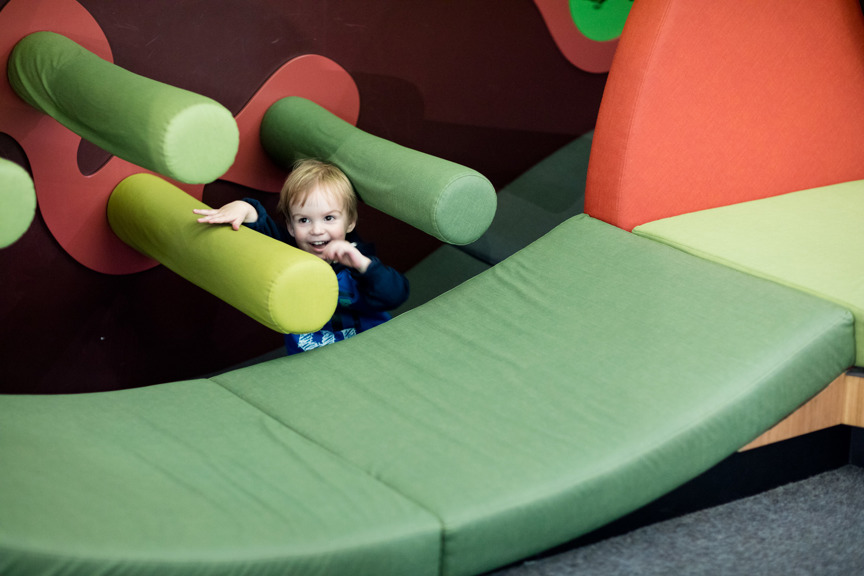 A toddler playing on mats